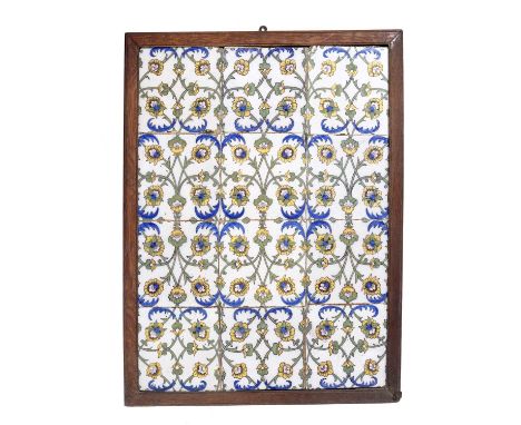 An 18th century European pottery tile panel, the twelve tiles forming a trellis of stylised yellow flowers, 60 x 44cm, framed