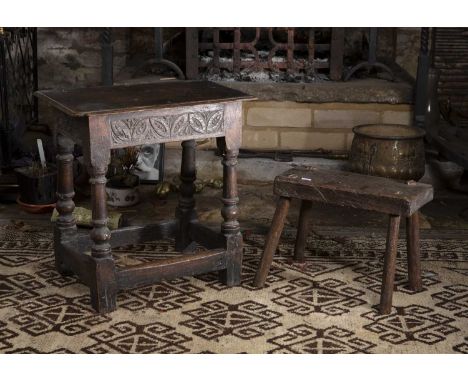 A late 17th/early 18th century oak joint stool, the frieze carved with stylised stretchers, 45.5cm; and a 19th century rustic