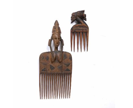 A large ceremonial West African Dogon hair comb, carved wood with a woman figure to top half and scratch work pattern desgin 