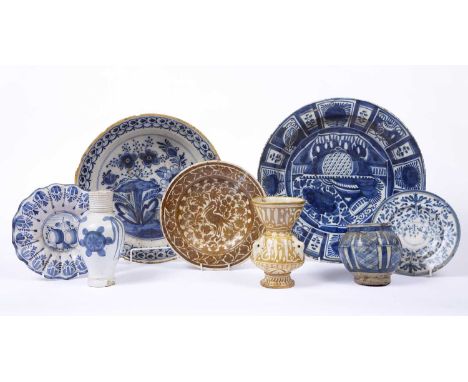 An 18th century Dutch Delft blue and white pottery deep bowl decorated a garden scene, 31cm; another 35cm diameter; and a col