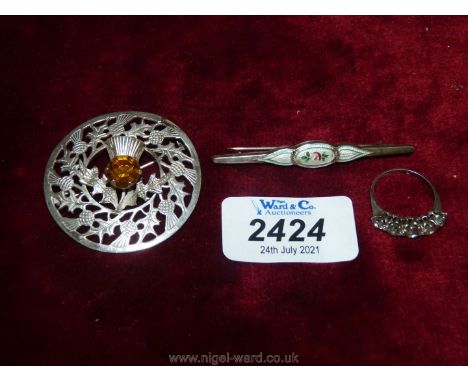 A Scottish silver thistle brooch, blue enamel pin brooch and a silver ring with white stones.