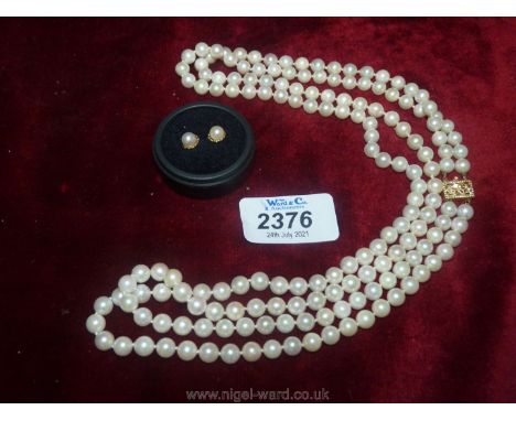 A pretty two strand Akoya Pearl Necklace, 62 cms long with 14k clasp and a pair of ear-rings.