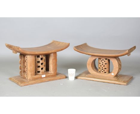 A pair of mid-20th century Ashanti carved wooden stools with pierced central supports, height 39cm, width 57cm and height 36c