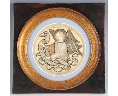 A small 18th/19th century silkwork and metal thread tondo panel, finely worked with an angel holding an inscribed banner, dia
