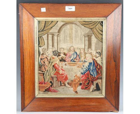 A 19th century Berlin woolwork panel depicting the Last Supper, 31cm x 27cm, within a period rosewood frame, together with a 