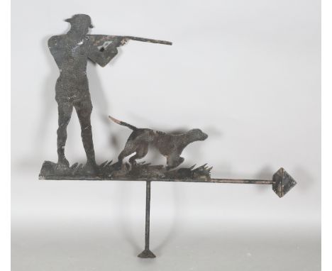 A 20th century sheet metal weather vane, worked as a huntsman and his dog attempting to shoot game, height 84cm, together wit