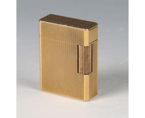 A Dupont Paris gilt metal rectangular gas lighter, the exterior with engine turned decoration, height 4.8cm.Buyer’s Premium 2