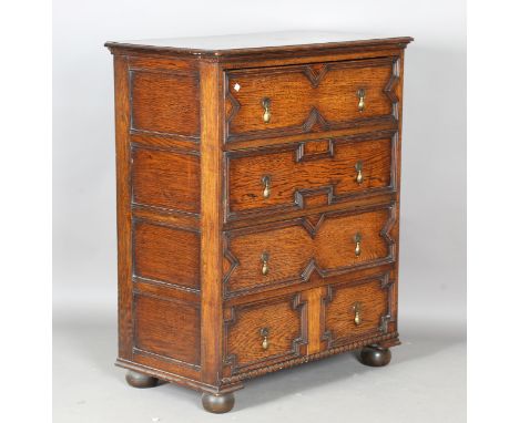 A George V Carolean Revival oak chest of four long drawers, on bracket feet, height 105cm, width 85cm, depth 48cm.Buyer’s Pre
