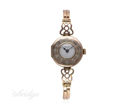 A LADIES 9CT SOLID GOLD ROLEX HALF HUNTER BRACELET WATCH CIRCA 1920s
D: White enamel dial. M: 15 jewel manual wind movement, 