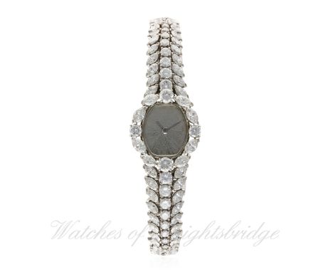 A FINE LADIES PLATINUM & DIAMOND LECOULTRE BRACELET WATCH CIRCA 1970s
D: Sunburst dial. M: 17 jewel manual wind movement sign