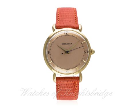 A GENTLEMAN'S LARGE SIZE 18K SOLID GOLD JAEGER LECOULTRE WRIST WATCH CIRCA 1950s 
D: Salmon pink dial with black quarterly Ar