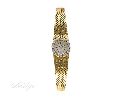 A LADIES 18K SOLID GOLD & DIAMOND OMEGA BRACELET WATCH CIRCA 1960s
D: Silver dial with black inlaid gilt batons. M: Manual ba