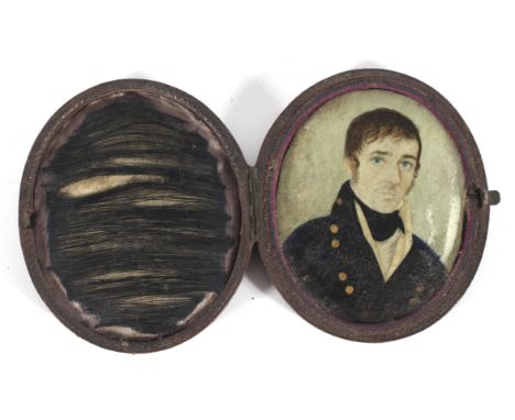 A Georgian portrait miniature of a gentleman on ivory, of oval form, in brown leather, 8 cm long 