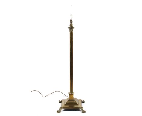 A brass corinthian column standard lamp, raised on lion paw feet, H120cm 