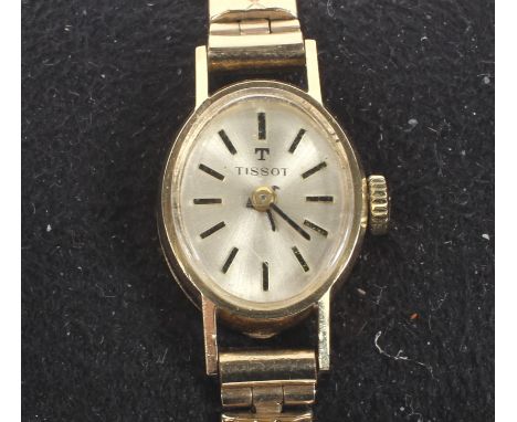 A 9ct gold cased ladies manual wind Tissot wristwatch, the silvered dial with baton hour markers, on expanding strap