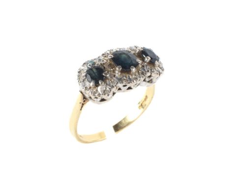 An 18ct gold and sapphire dress ring the central sapphire flanked by two smaller all surounded by diamonds, size R, weight 6.