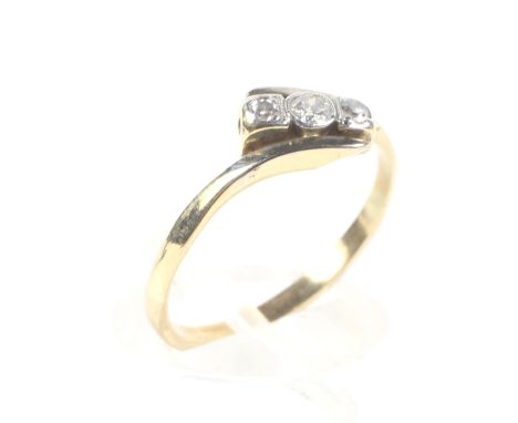 A gold (unmarked) three stone diamond ring with circular mounts, 2.1g, size M