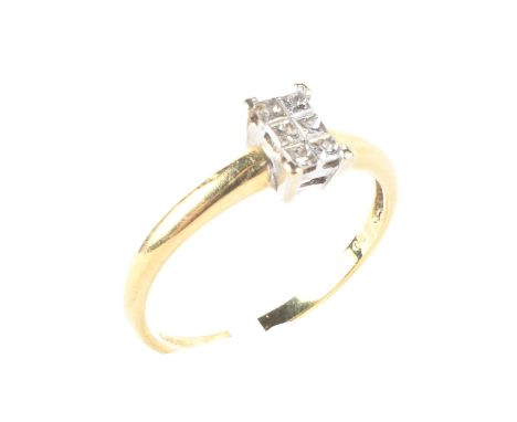 An 18ct gold diamond ring, set with six square cut diamonds giving an illusion of a solitaire ring, 2.5 grams, size O