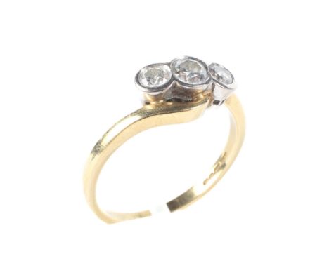 An 18ct gold three stone diamond ring, with twisted shoulders size O 4.5 grams