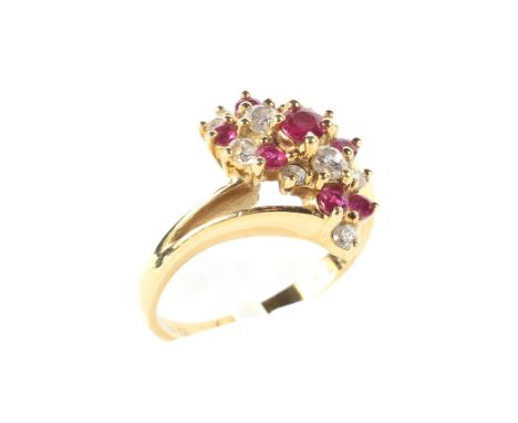 An 18ct yellow gold diamond and ruby dress ring, set in a twisted double shoulder setting, size I, 3.6 gram