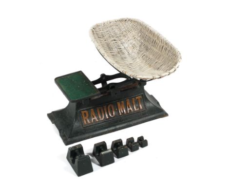 A set of vintage Radio-Malt advertising cast iron baby scales, with weights and wicker basket, painted in green with gilt let