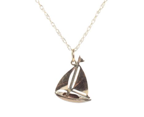 A yellow metal pendant in the form of a boat on chain, the chain marked 9k, approx 1.1g