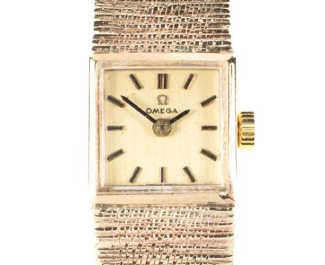 A vintage 9ct gold ladies Omega cocktail wristwatch, with original gold strap, the square gilt dial with batons denoting hour