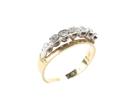 An 18ct gold and diamond dress ring, the diamons of near matched size raised on a continuous band of 18ct gold, size N, weigh