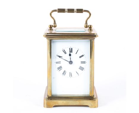 A French 20th century eight day brass carriage clock, the white enamelled dial with Roman numerals within bevelled glass pane