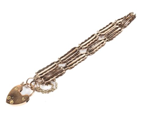 A 9ct rose gold gate bracelet with heart locket, 12.4g