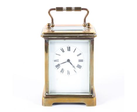 A French 20th century eight day brass carriage clock, the white enamelled dial with Roman numerals, within bevelled glass pan