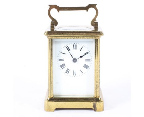 A brass carriage clock in a leather travelling case, early 20th century, with white enamelled dial and black Roman numerals, 