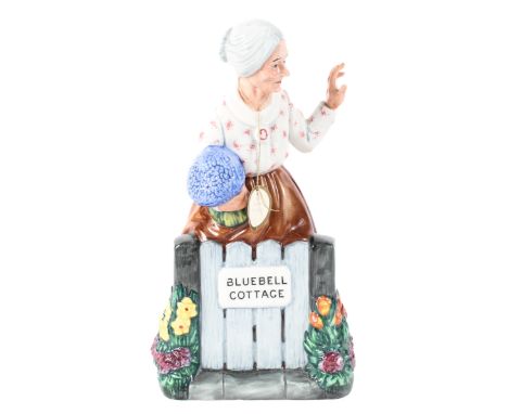 A Royal Doulton figure of an old lady at her cottage gate, titled 'Thank You', printed green marks, HN2732, 21cm high