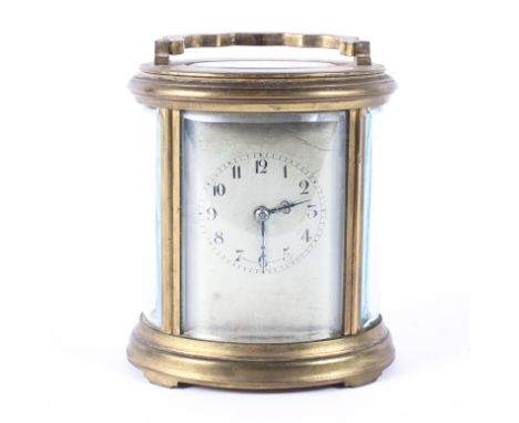 A French oval brass carriage clock, early 20th century, the silvered dial with Arabic numerals, within bevelled glass panels,