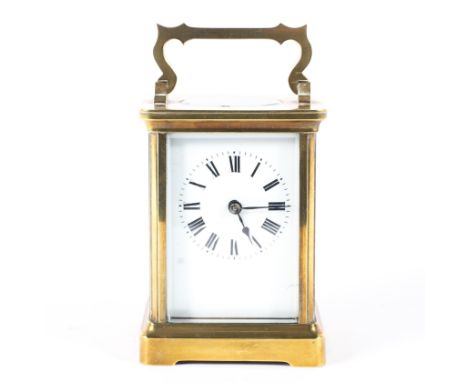 A 20th century brass eight day carriage clock, the white enamelled dial with Roman numerals, within bevelled glass panels, wi
