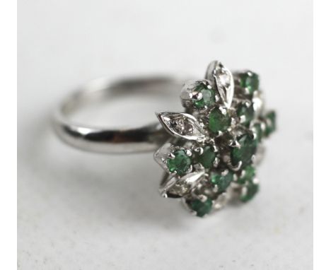 Unmarked white gold diamond and emerald flower ring, 4.6g