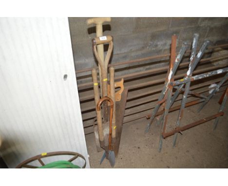 A quantity of long handled gardening tools to include a spade; a folk; loppers; hand saw etc