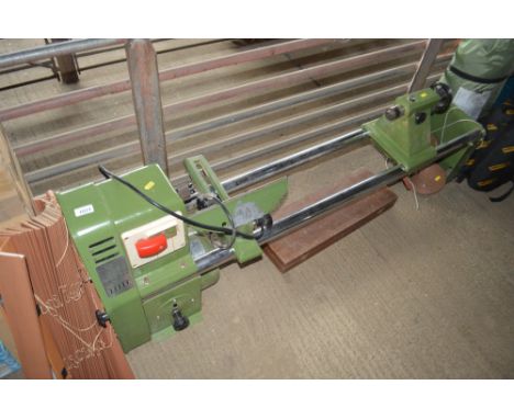 A wood turning lathe with a box of various tools