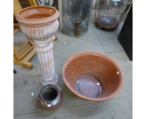 A large terracotta bowl, a terracotta jardiniere on stand and a pottery urn 