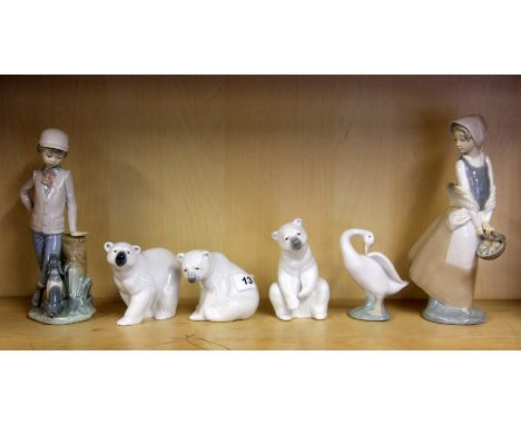 Three Lladro porcelain polar bears, together with a Lladro porcelain model Little Duck and two Nao porcelain figurines.