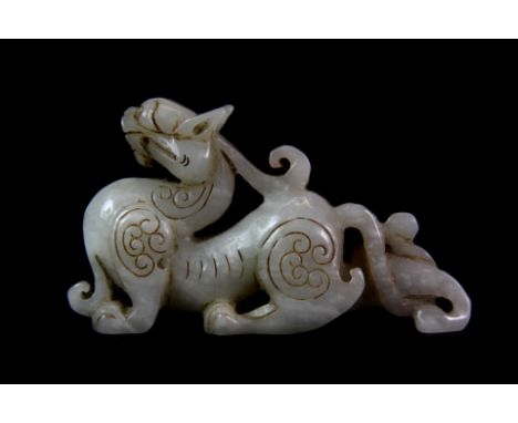 A Chinese mutton fat jade figure of a dragon. L. 10cm H. 5.5cm. Est. £150 - 200