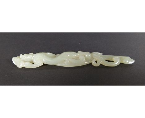 A 19th / early 20th century Chinese carved celadon jade figure of an elongated dragon, L. 12.5cm. £150 - 200
