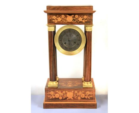 A Regency style inlaid and gilt brass portico mantle clock, H. 49cm.