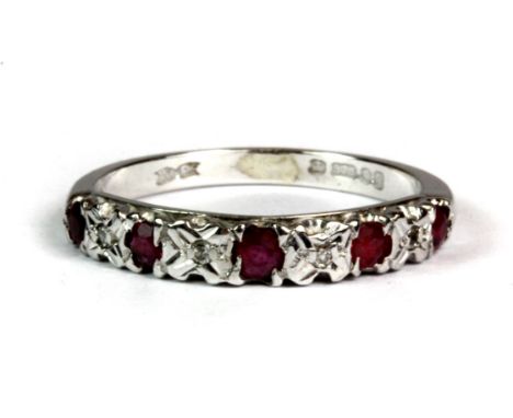 A 9ct white gold ruby and diamond half eternity ring (O.5).