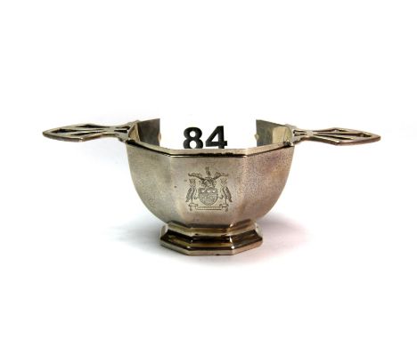 A Sheffield c. 1932 hallmarked silver tea strainer with The Leeds coat of arms engraved to the side, H. 4cm, Dia. 5.8cm.