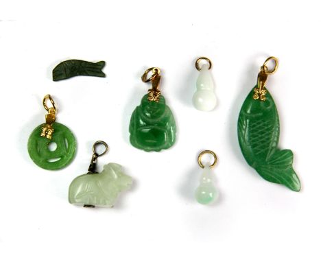 A small group of caved jade pendants, longest 3.5cm.