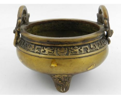 A Chinese bronze incense burner, having twin handles in form of dragons, raised on three feet, bears Chinese character mark t