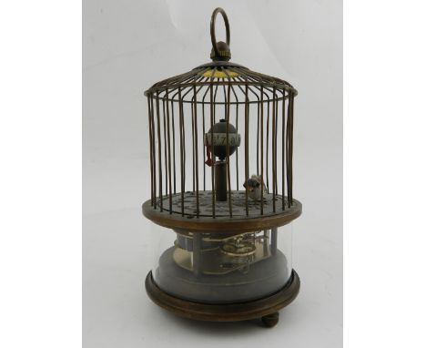 An automaton clock, in the form of a birdcage. 