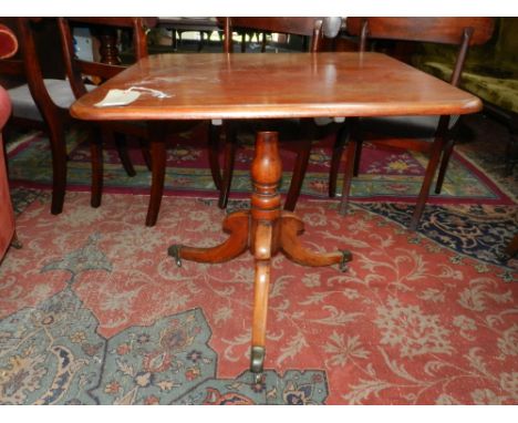 A 19th century square oak tilt top table, supported on tripod base and casters. H.70cm