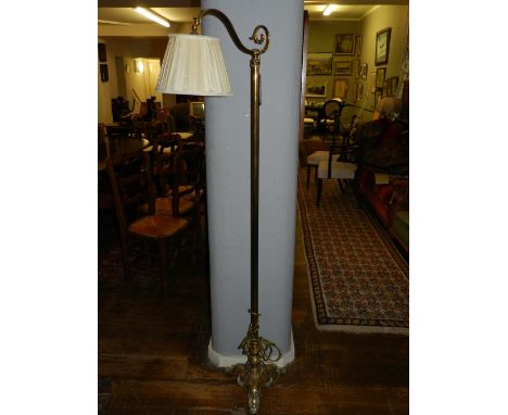 An early 20th century brass standing lamp, with shade. H.170cm